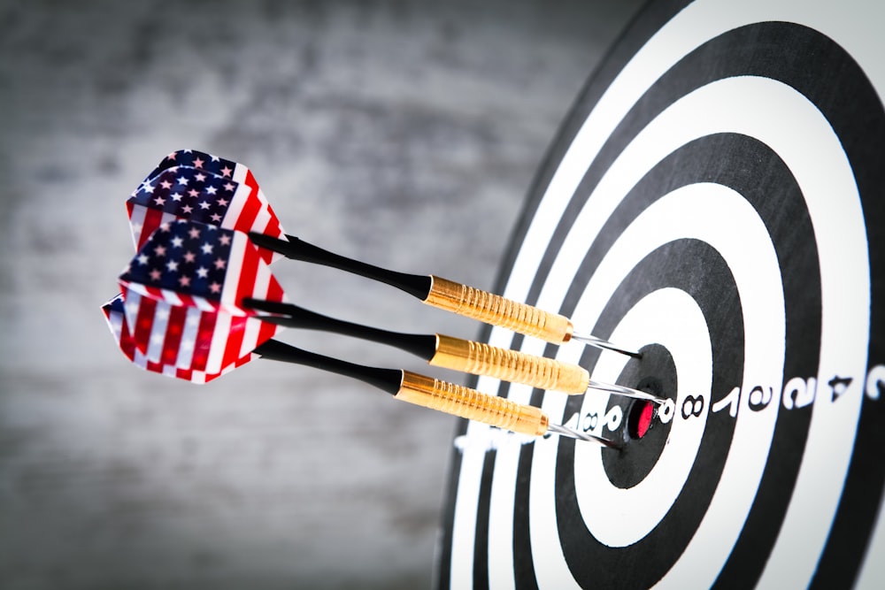 a dart hitting in the center of a target with an american flag on it