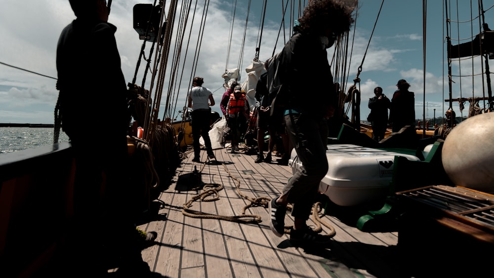 a group of people standing on the deck of a boat