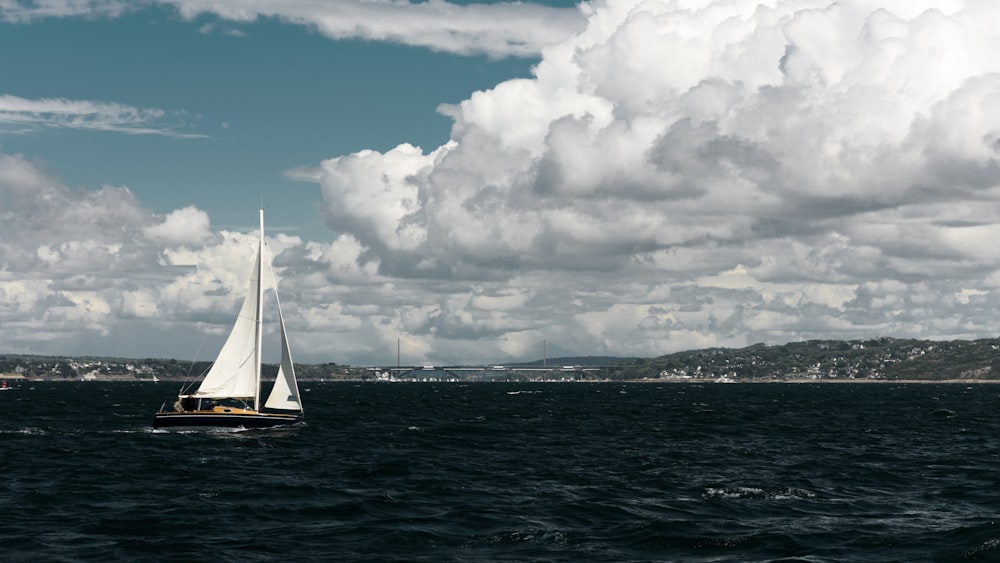 a sailboat in the middle of a body of water