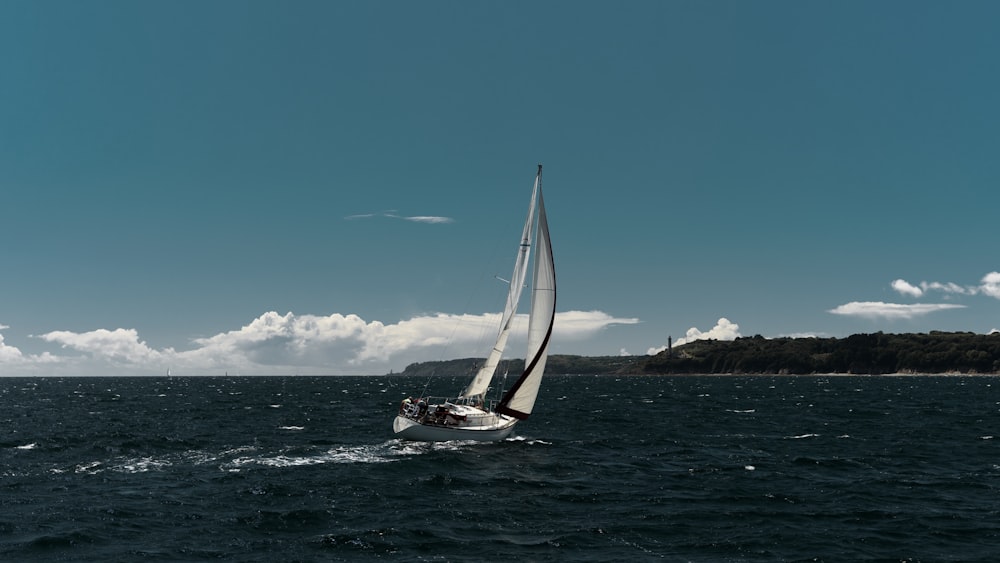 a sailboat sailing on a body of water