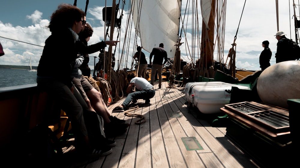 a group of people standing on top of a boat