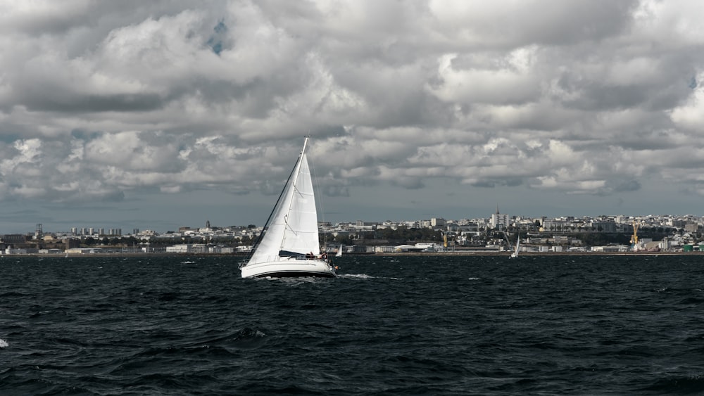 a sailboat in the middle of a body of water