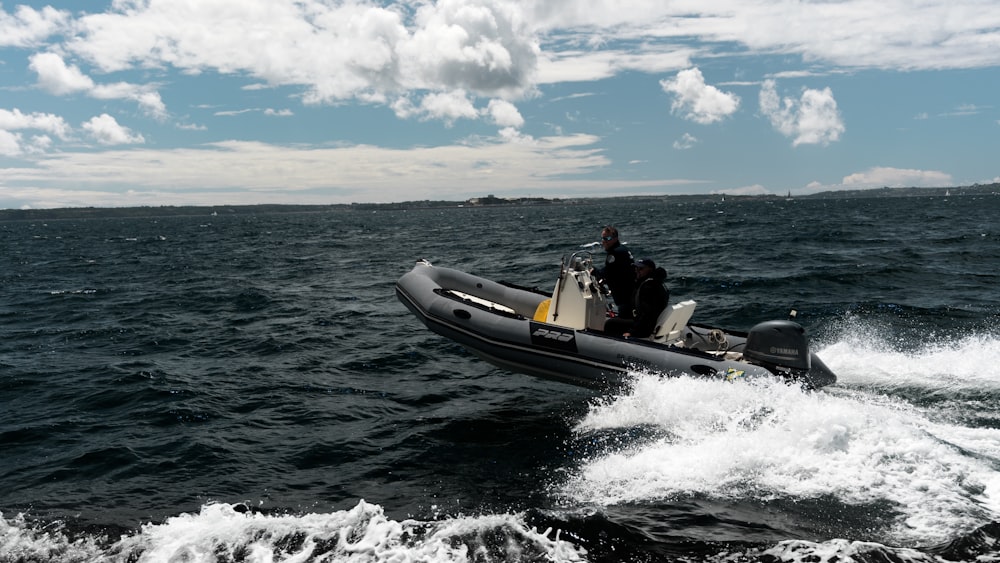 a man riding on the back of a boat in the ocean