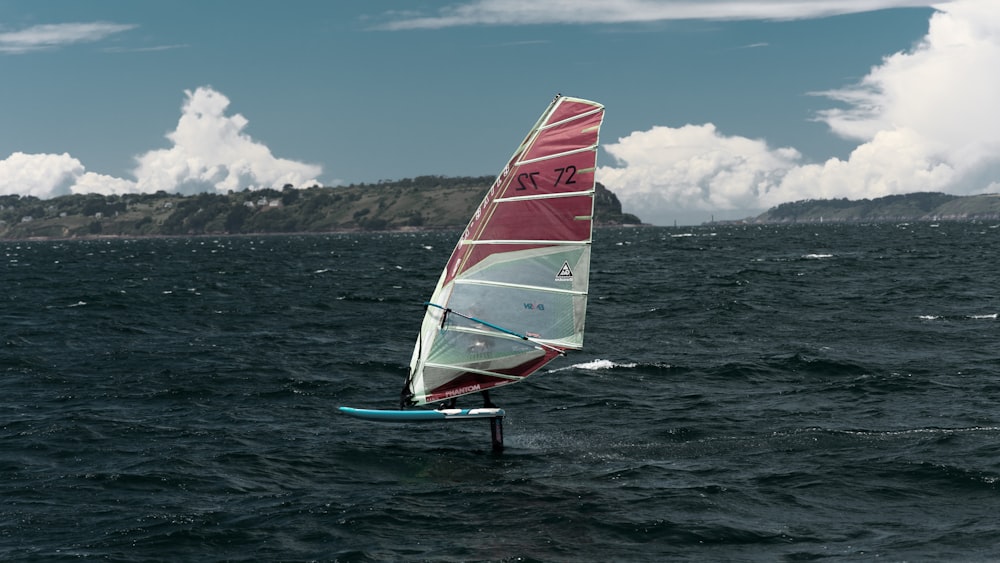 a person riding a sail boat on a body of water