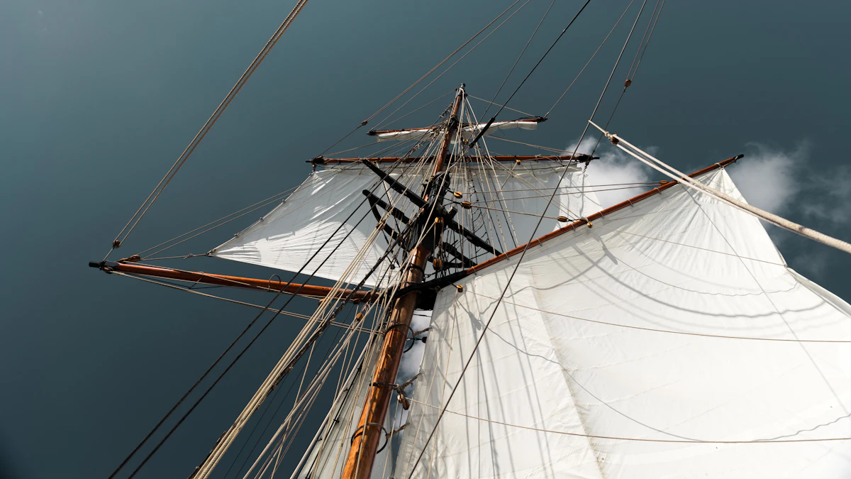 White sailing ship with tall masts against a blue sky