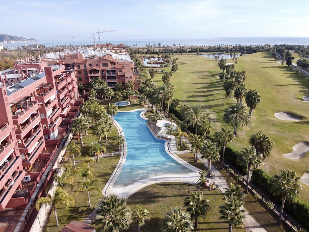 an aerial view of a resort with a swimming pool