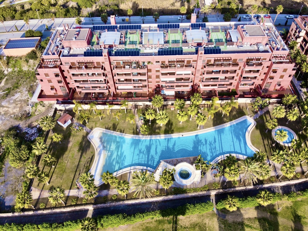 an aerial view of a building with a swimming pool