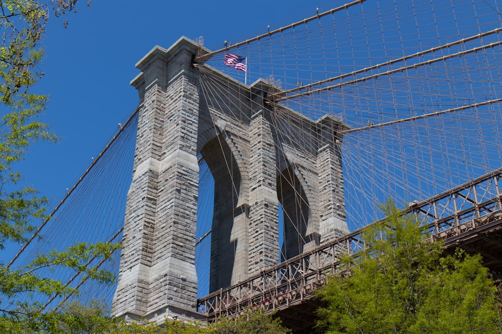 a tall bridge with a flag on top of it