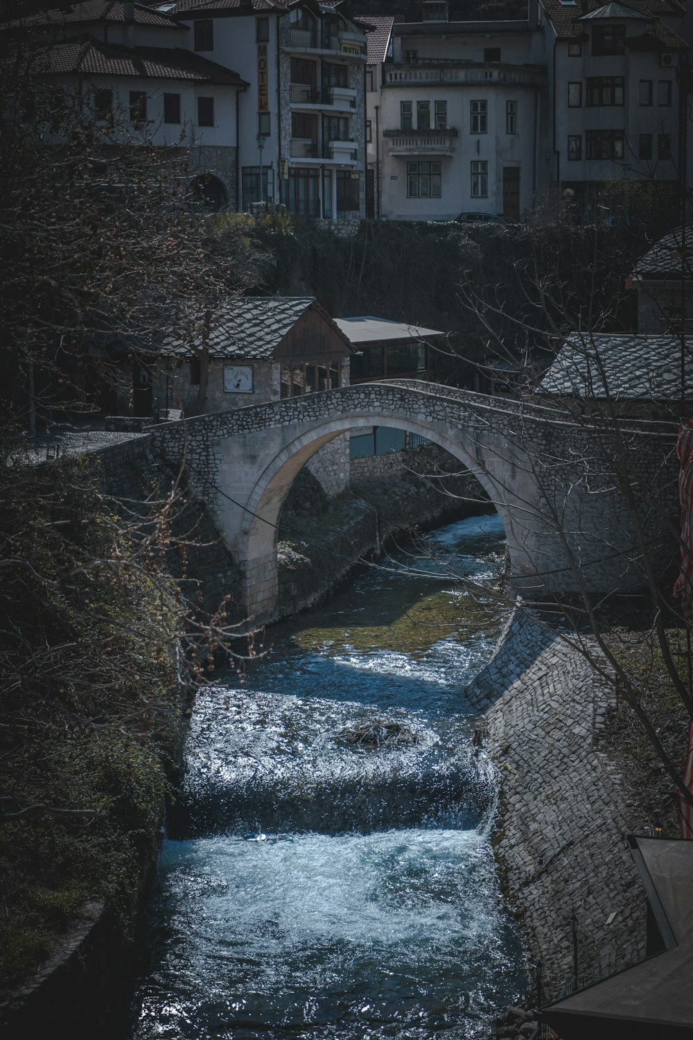 a bridge over a river with buildings in the background