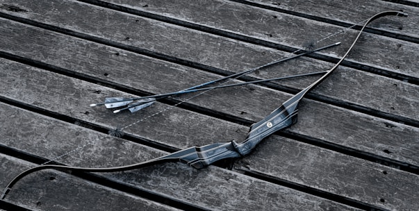 Close-up of a bow and arrow set displayed in the quwwah archery online store.
