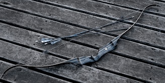 a broken umbrella sitting on top of a wooden bench