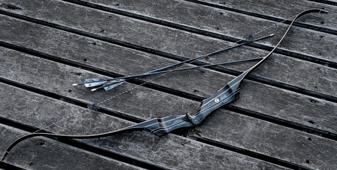 a broken umbrella sitting on top of a wooden bench