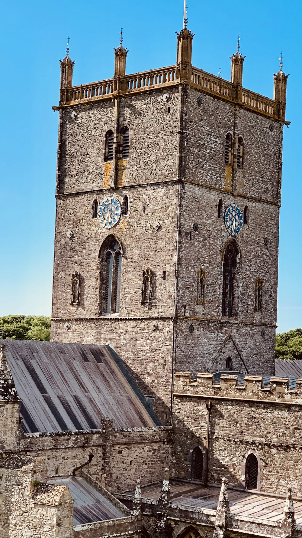 a tall brick tower with a clock on it's side