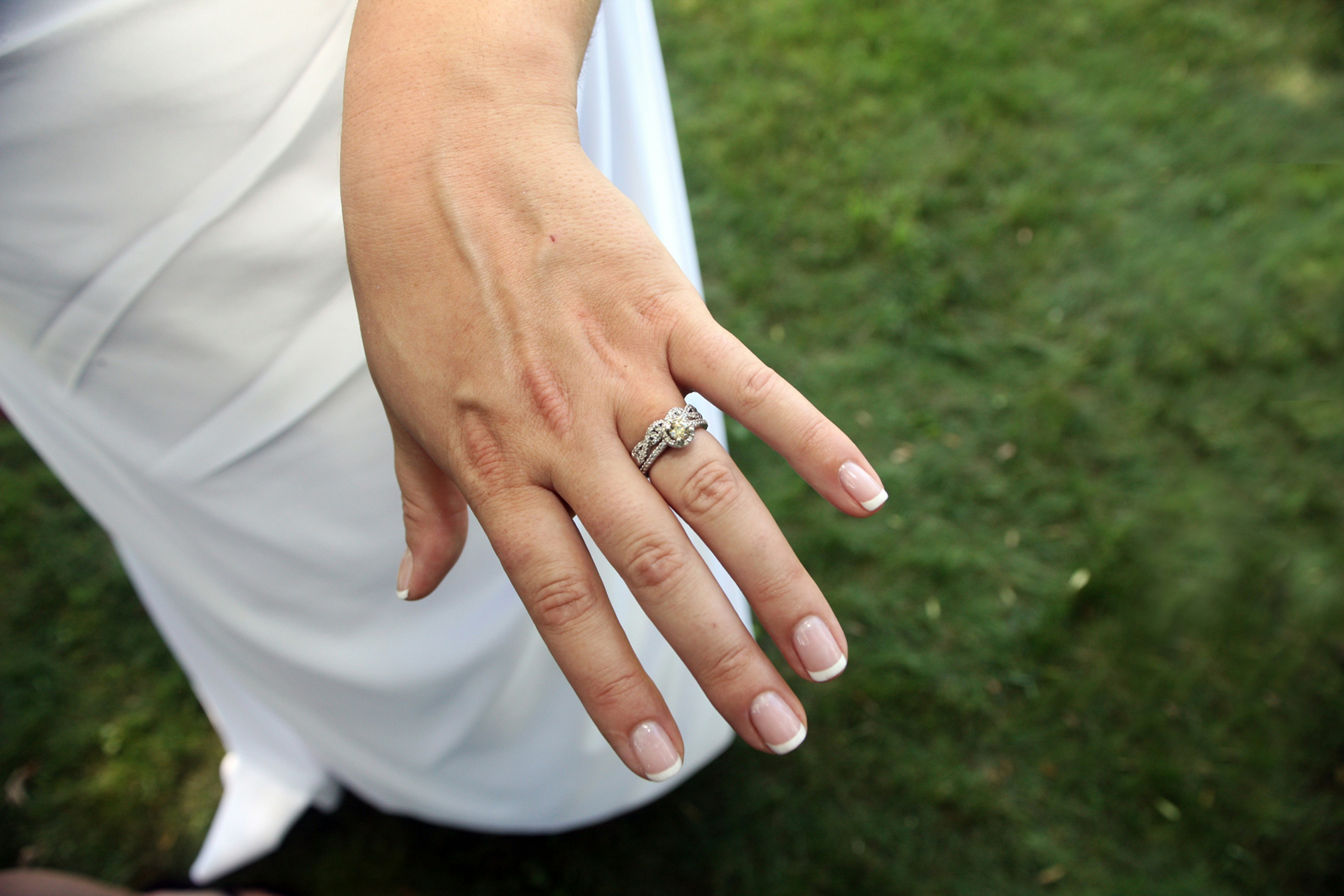 a close up of a person wearing a wedding ring