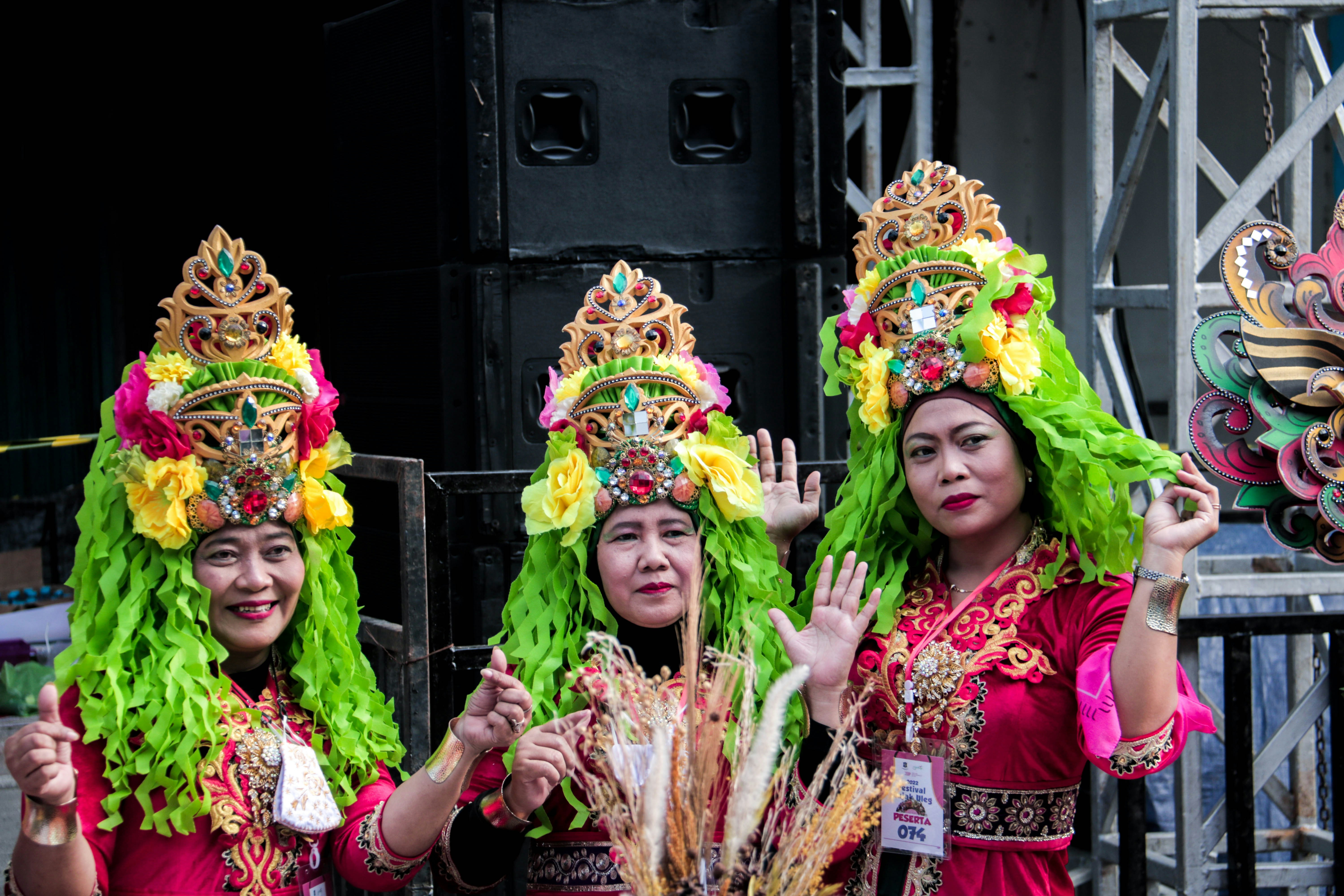 a group of women in colorful costumes standing next to each other