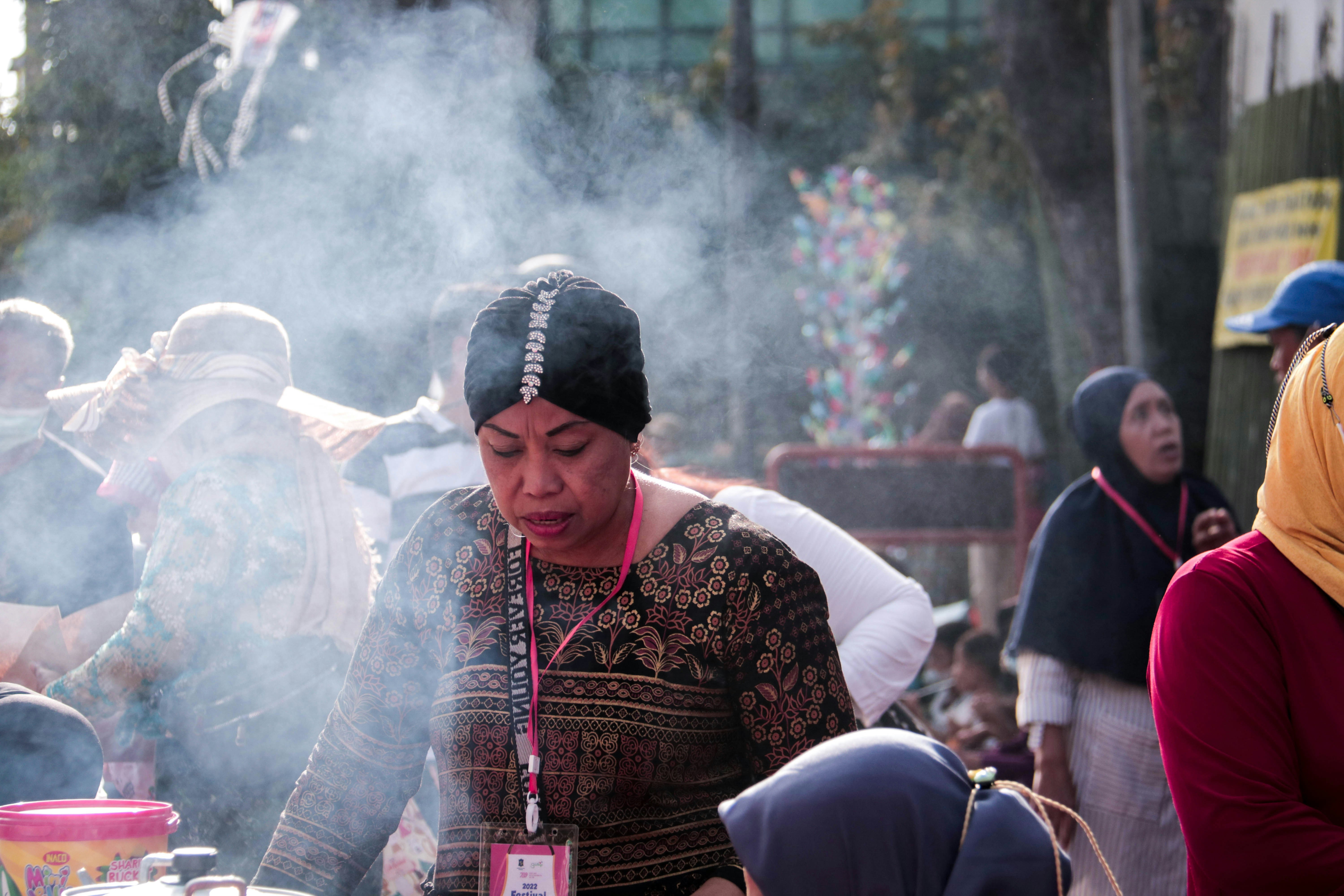 a woman standing in front of a table filled with food