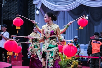 a woman in a colorful dress holding a stick