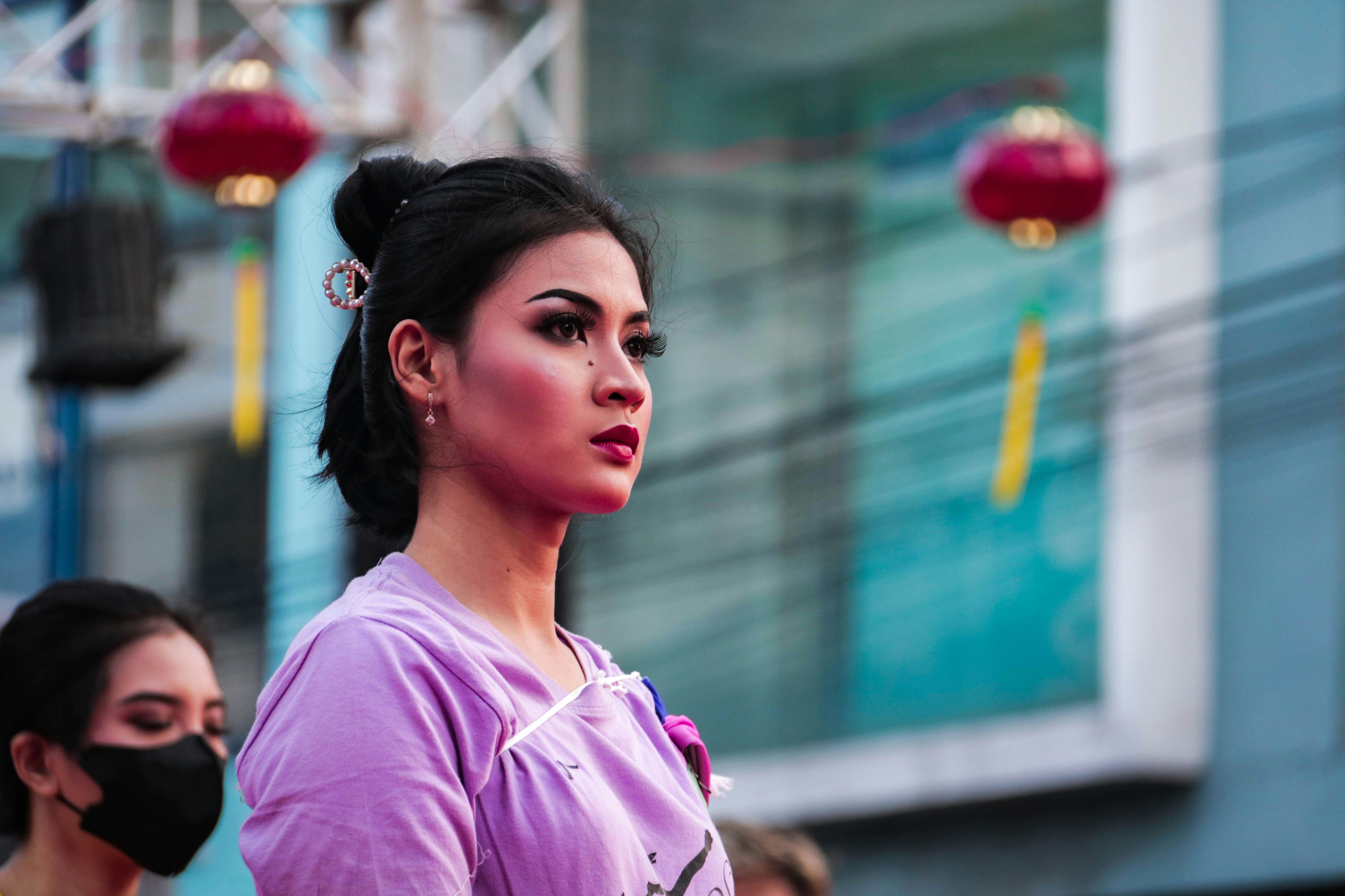 a woman wearing a face mask on a city street