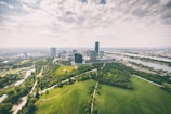 Aerial view of a modern city with green spaces and technology hubs.