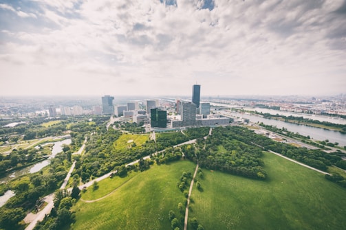 Aerial view of a modern city with green spaces and technology hubs.