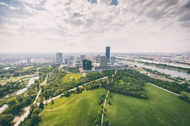 Aerial view of a modern city with green spaces.