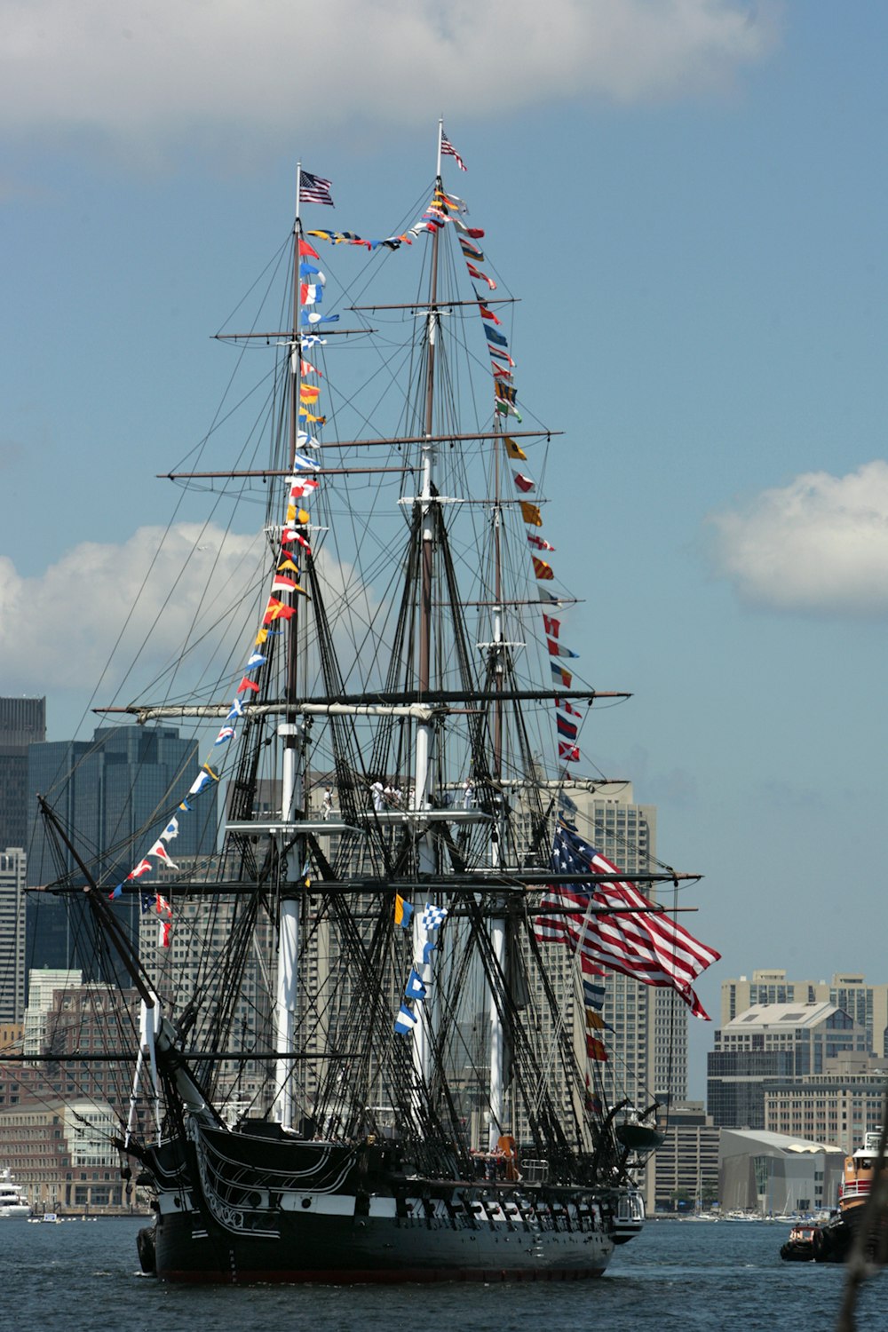 a tall ship with many flags on it