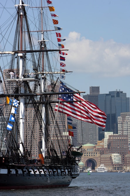 a tall ship with a lot of flags on it