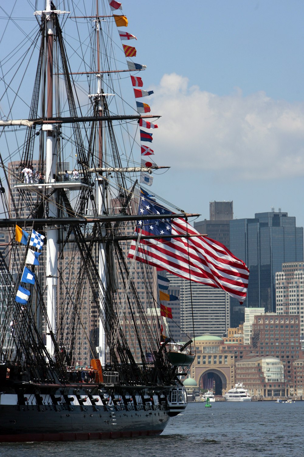 a tall ship with a lot of flags on it