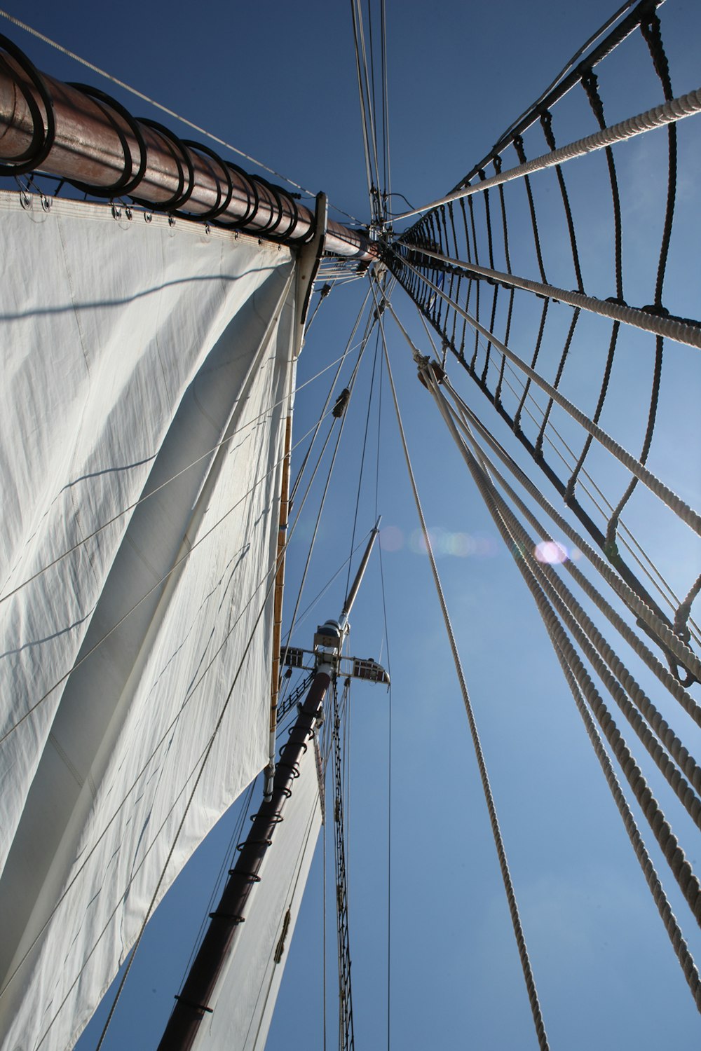 looking up at the sails of a sailboat