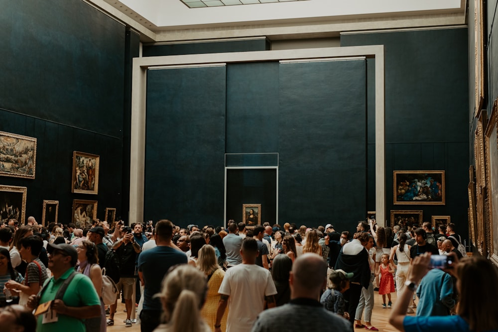 a large group of people standing in a room