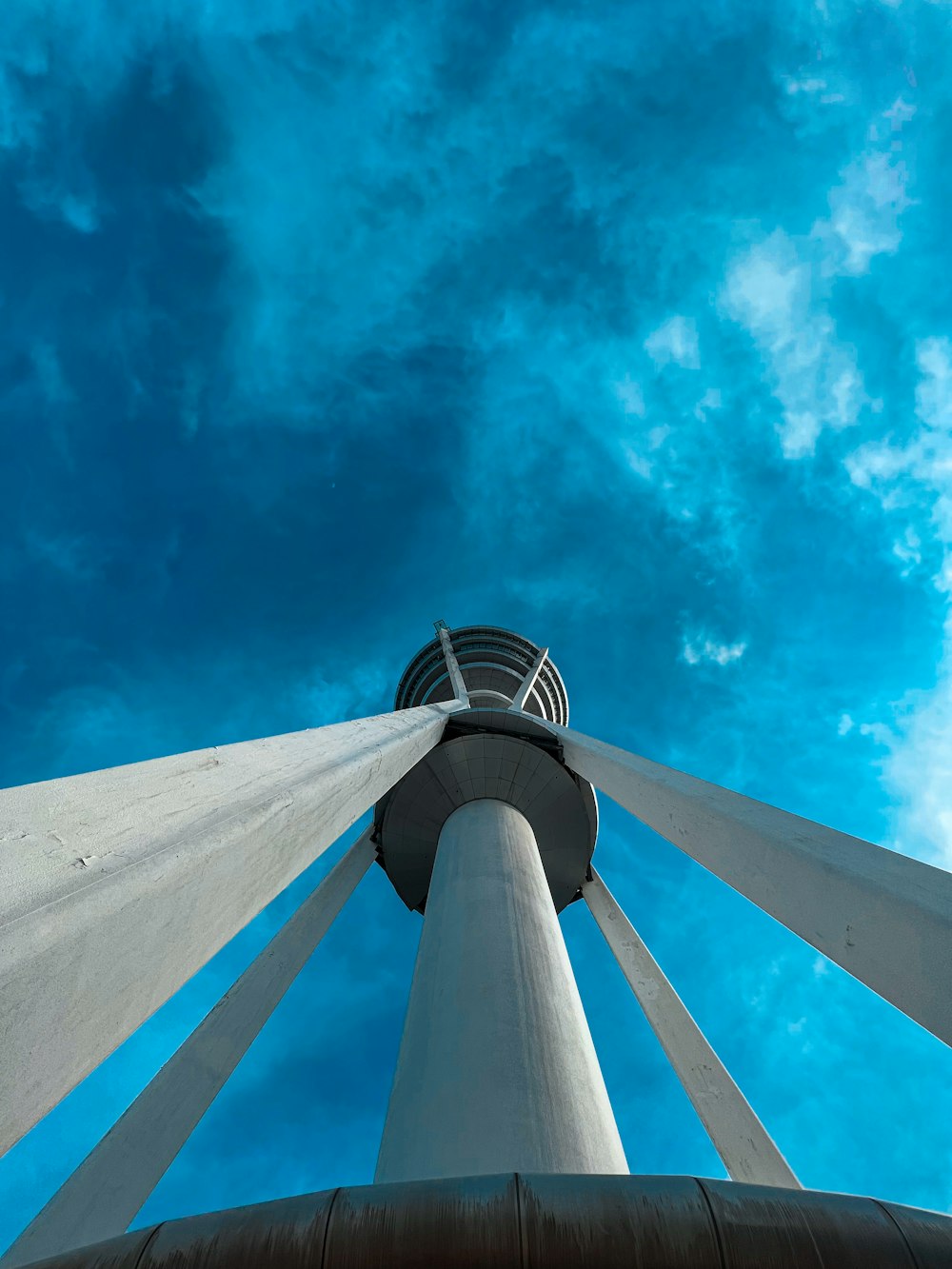 a tall white tower with a blue sky in the background