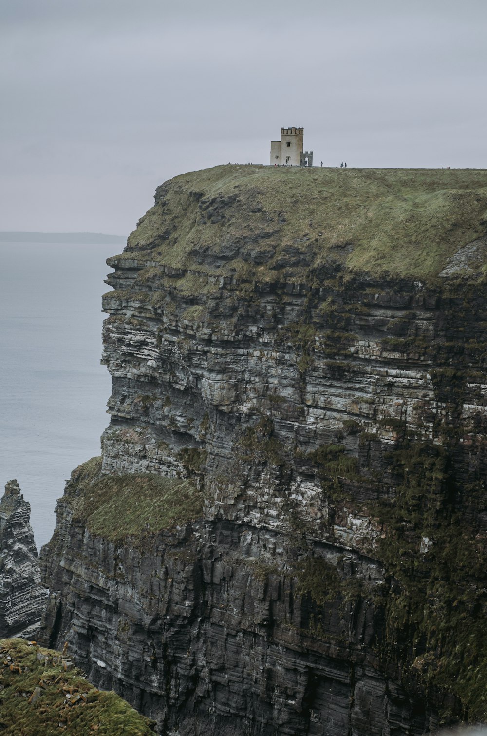 a tall cliff with a tower on top of it