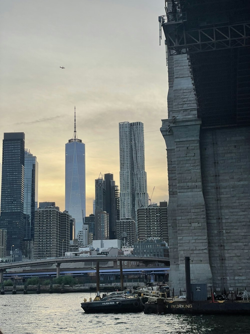 a boat traveling down a river next to tall buildings