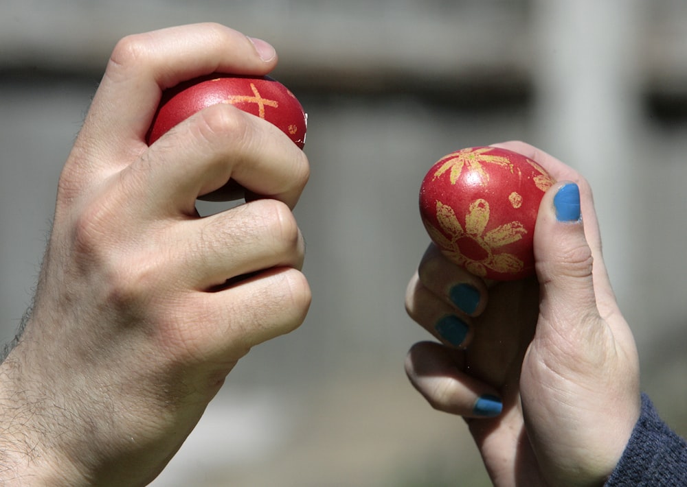 a person holding a small red object in their hands