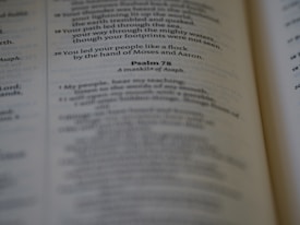 A close-up view of an open book displaying a page with text. The text appears to be a passage from Psalm 78, with some words highlighted or bolded. The page is slightly blurred on the edges, giving the image a soft focus effect.