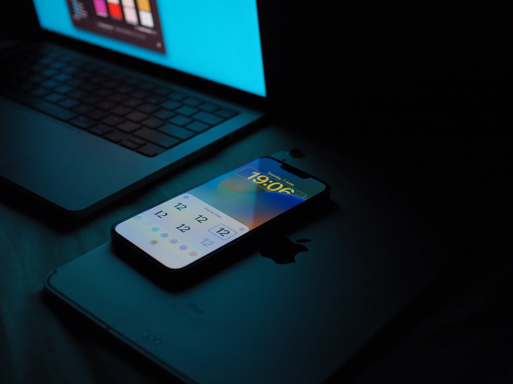 Smartphone beside a developer laptop for mobile application engineering