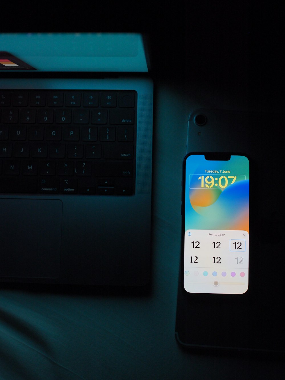 a cell phone sitting next to a laptop computer