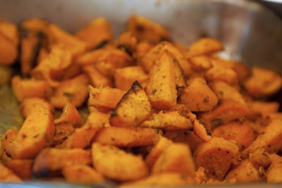 Close-up of a perfectly baked air fryer sweet potato topped with herbs