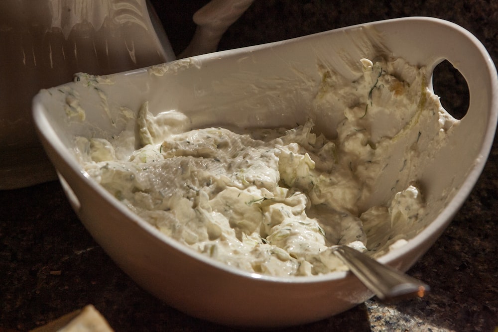 a bowl of mashed potatoes with a spoon in it