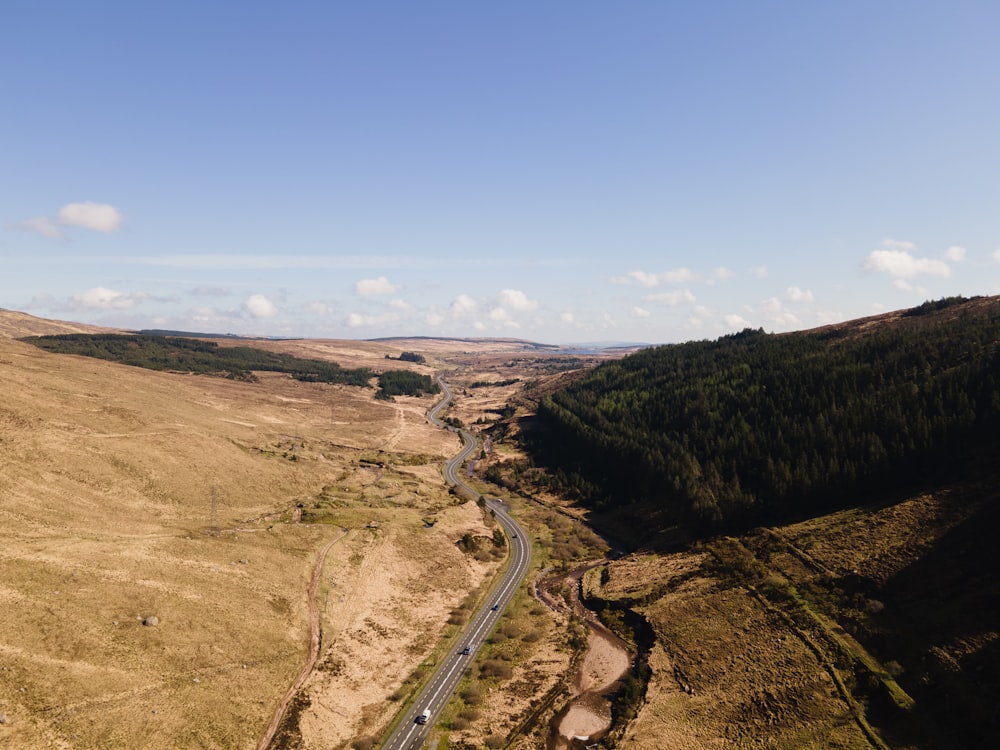 an aerial view of a winding road in the countryside