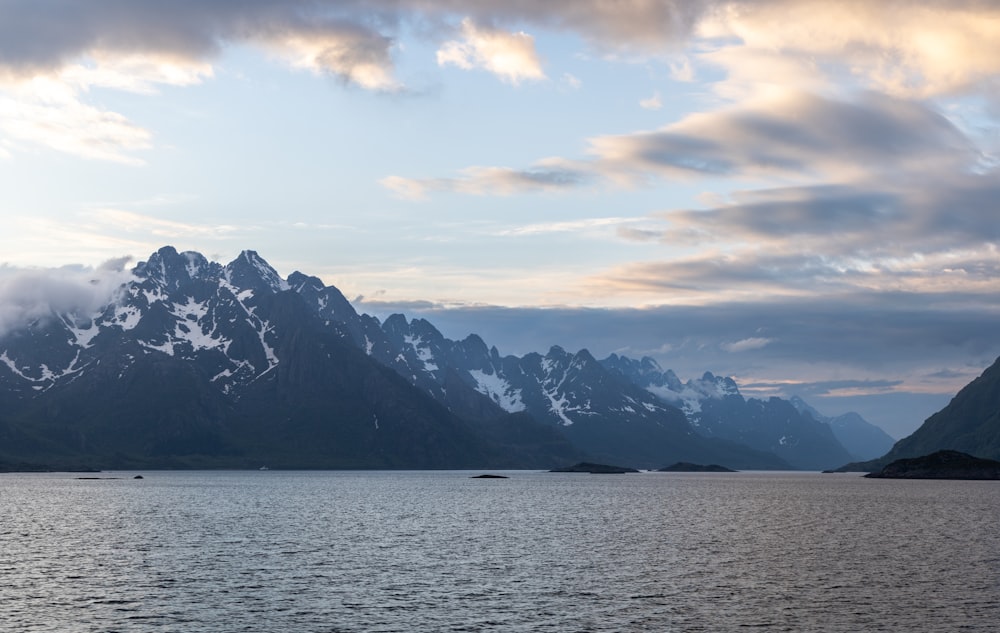 a large body of water with mountains in the background