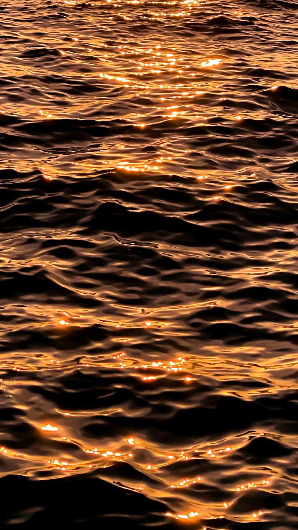 a large body of water with a boat in the distance