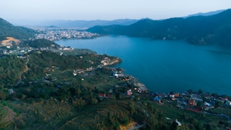 an aerial view of a town and a body of water