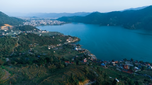 an aerial view of a town and a body of water