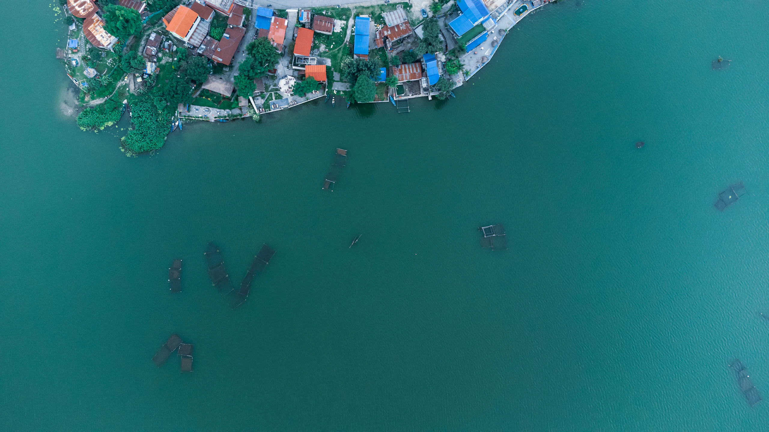 Aerial view of Pokhara along the calm shore of Phewa Lake with the hills beyond, Nepal
