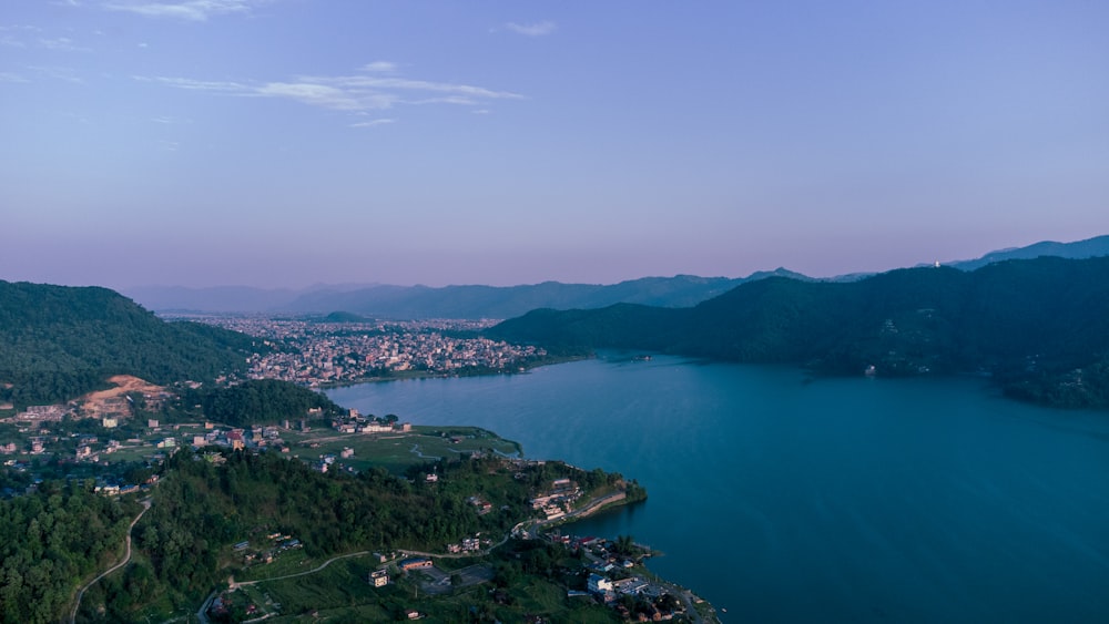 an aerial view of a lake surrounded by mountains