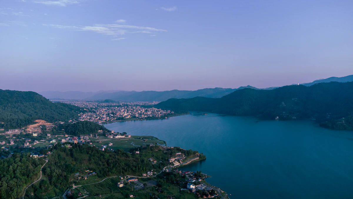 Pokhara and Phewa Lake from the air, with green hills around the water