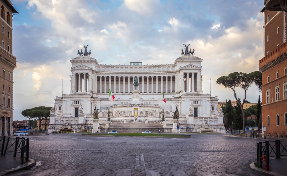 Piazza Venezia with a clock on the side of a road