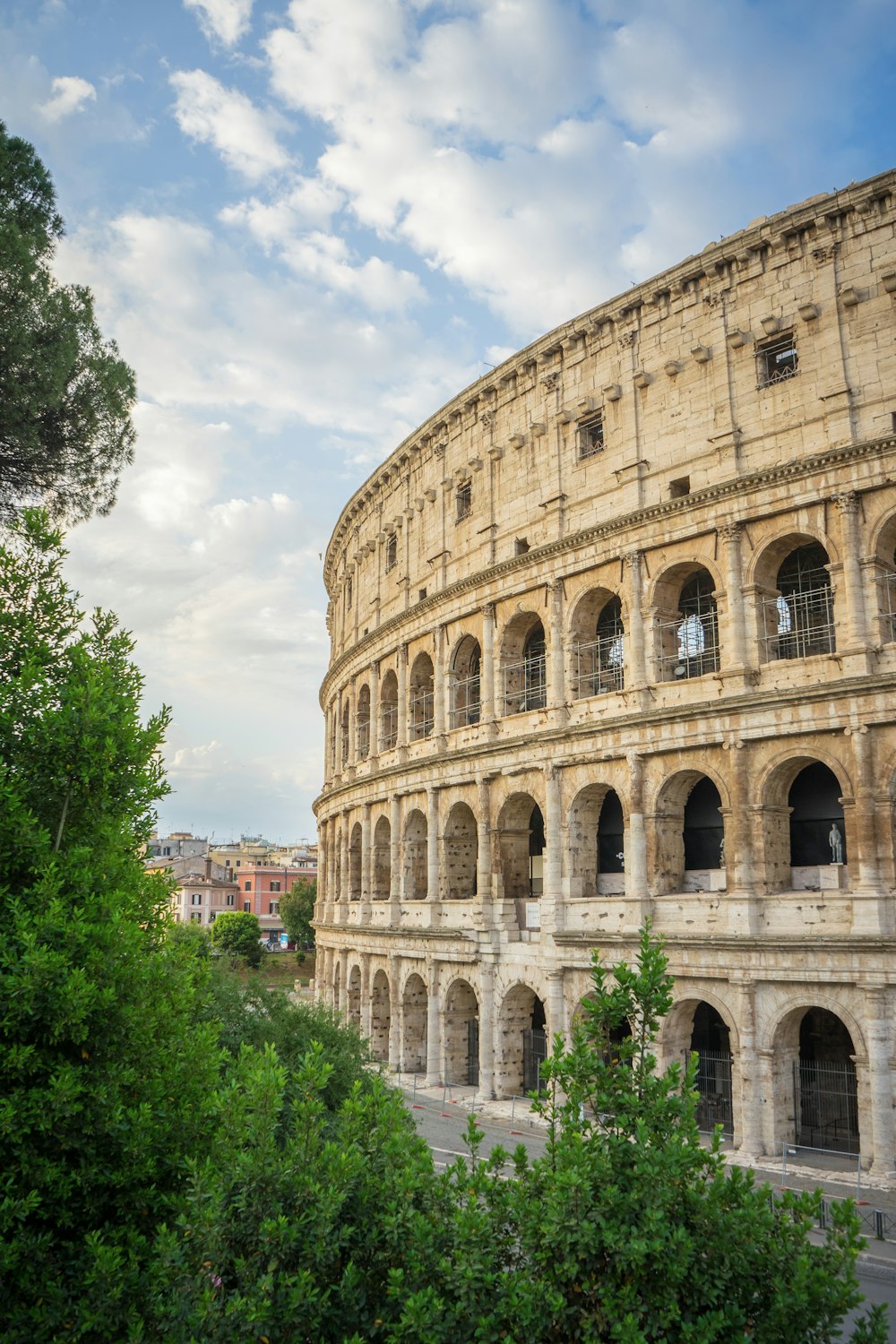 a large stone building with Colosseum in the background