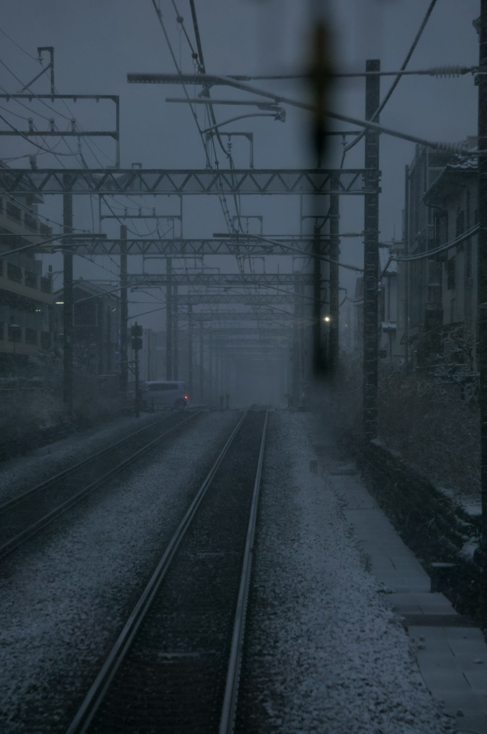 a foggy train station with a train on the tracks